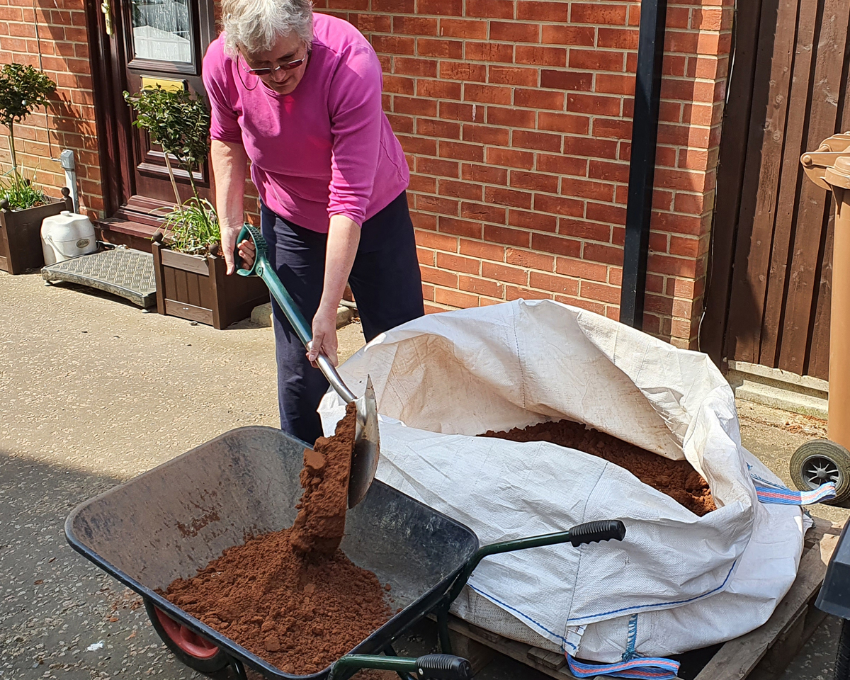 Filling the hole with soil.
